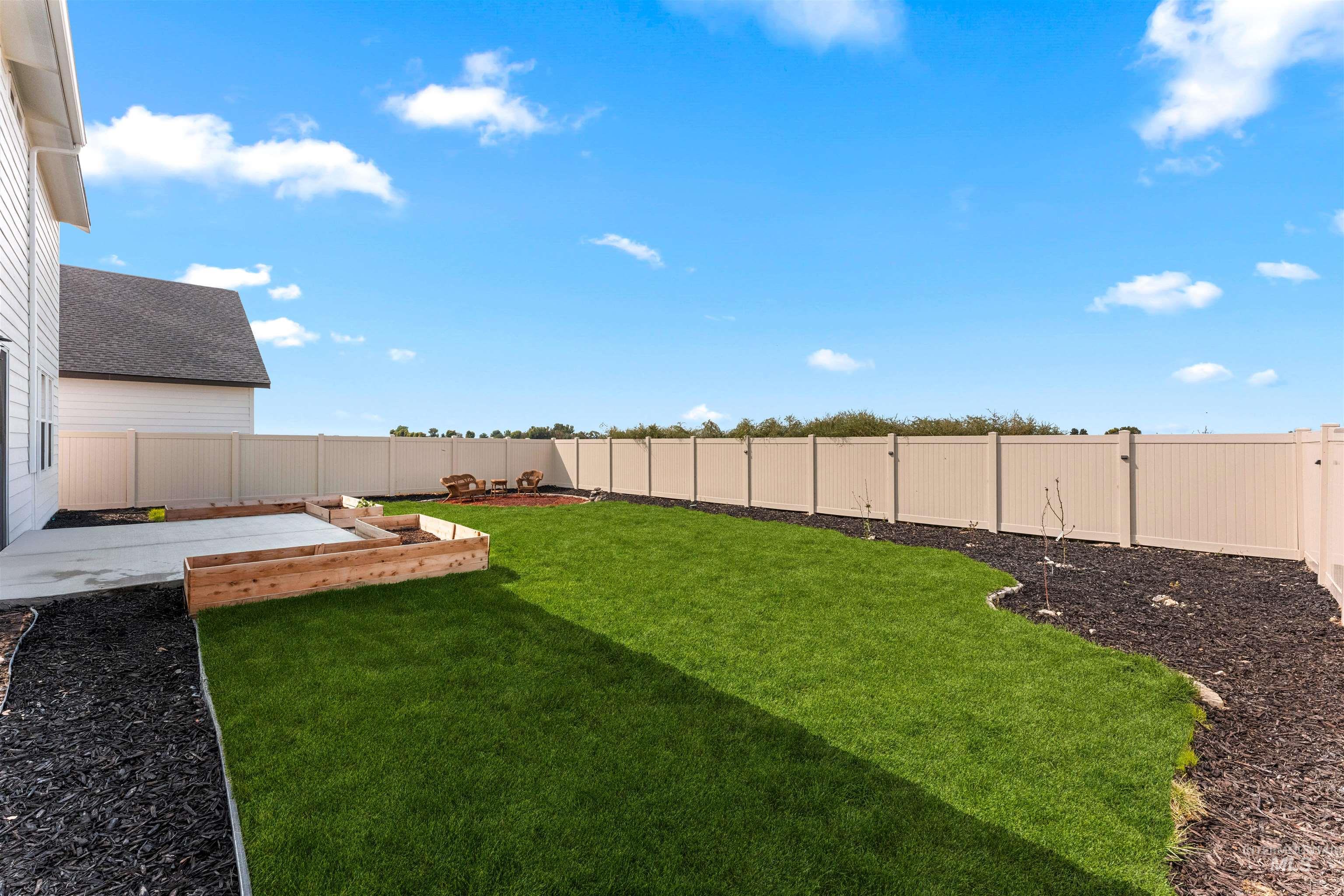 Fenced backyard with a patio