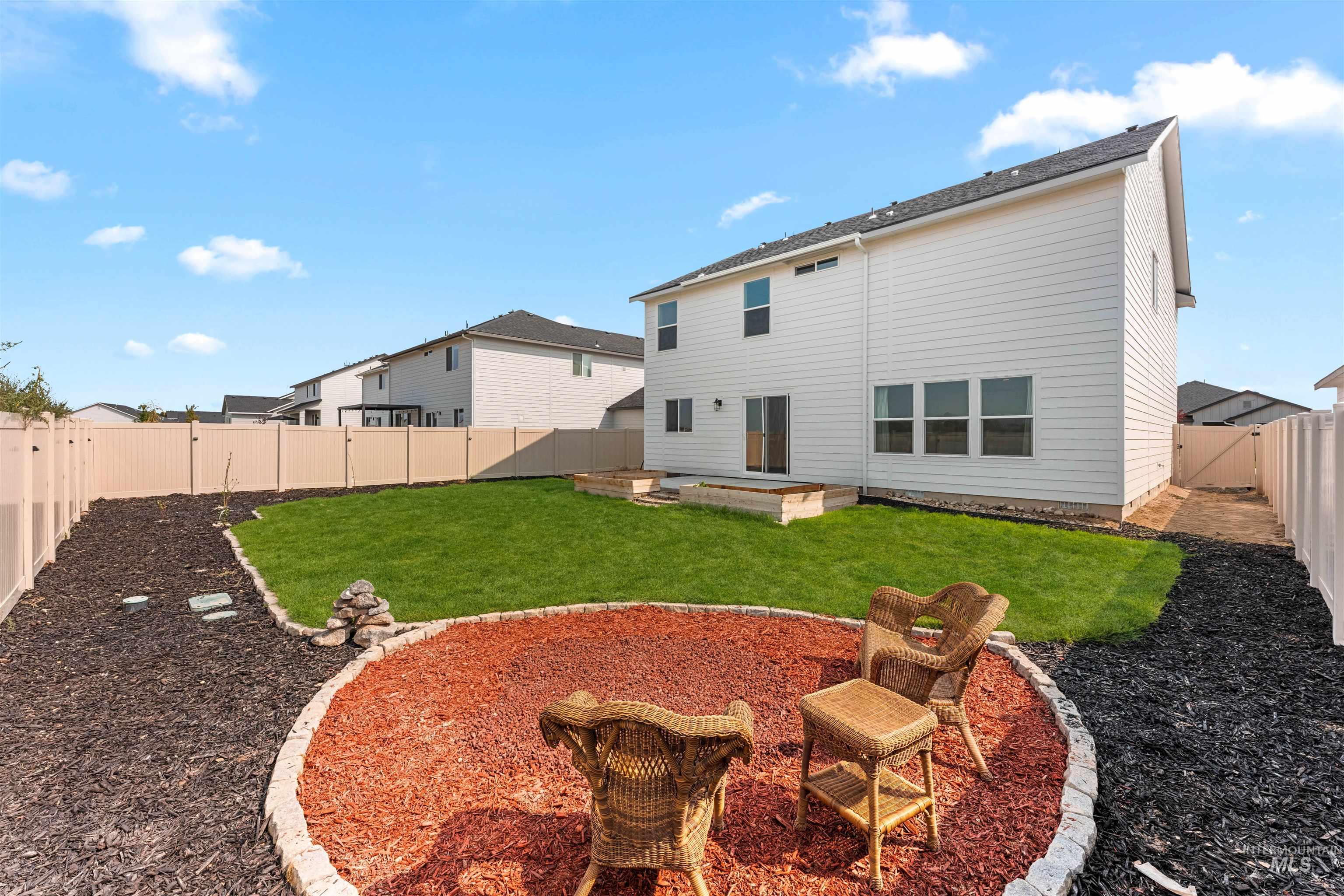 Back of property featuring a patio, an outdoor fire pit, and a fenced backyard