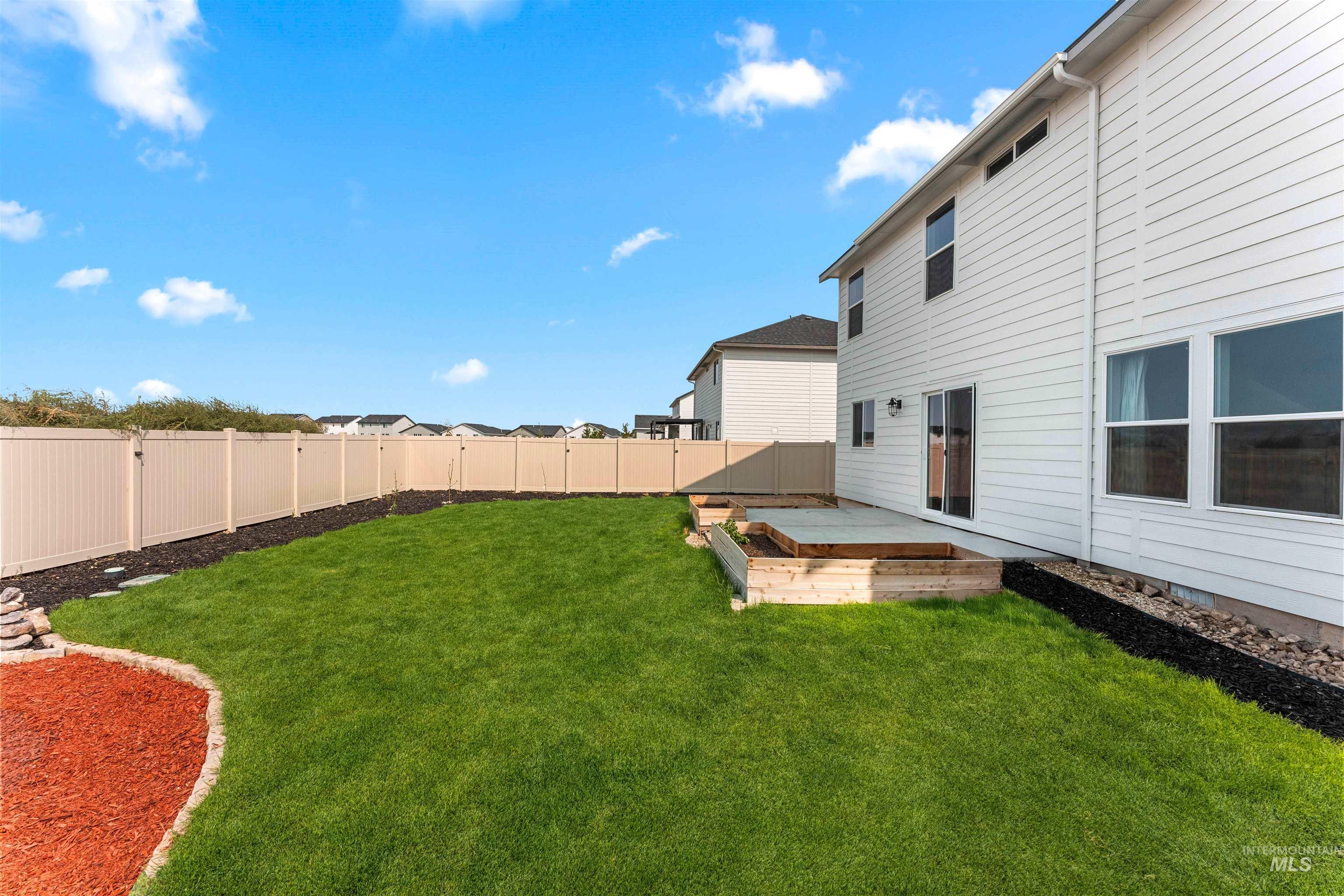 Fenced backyard with a wooden deck
