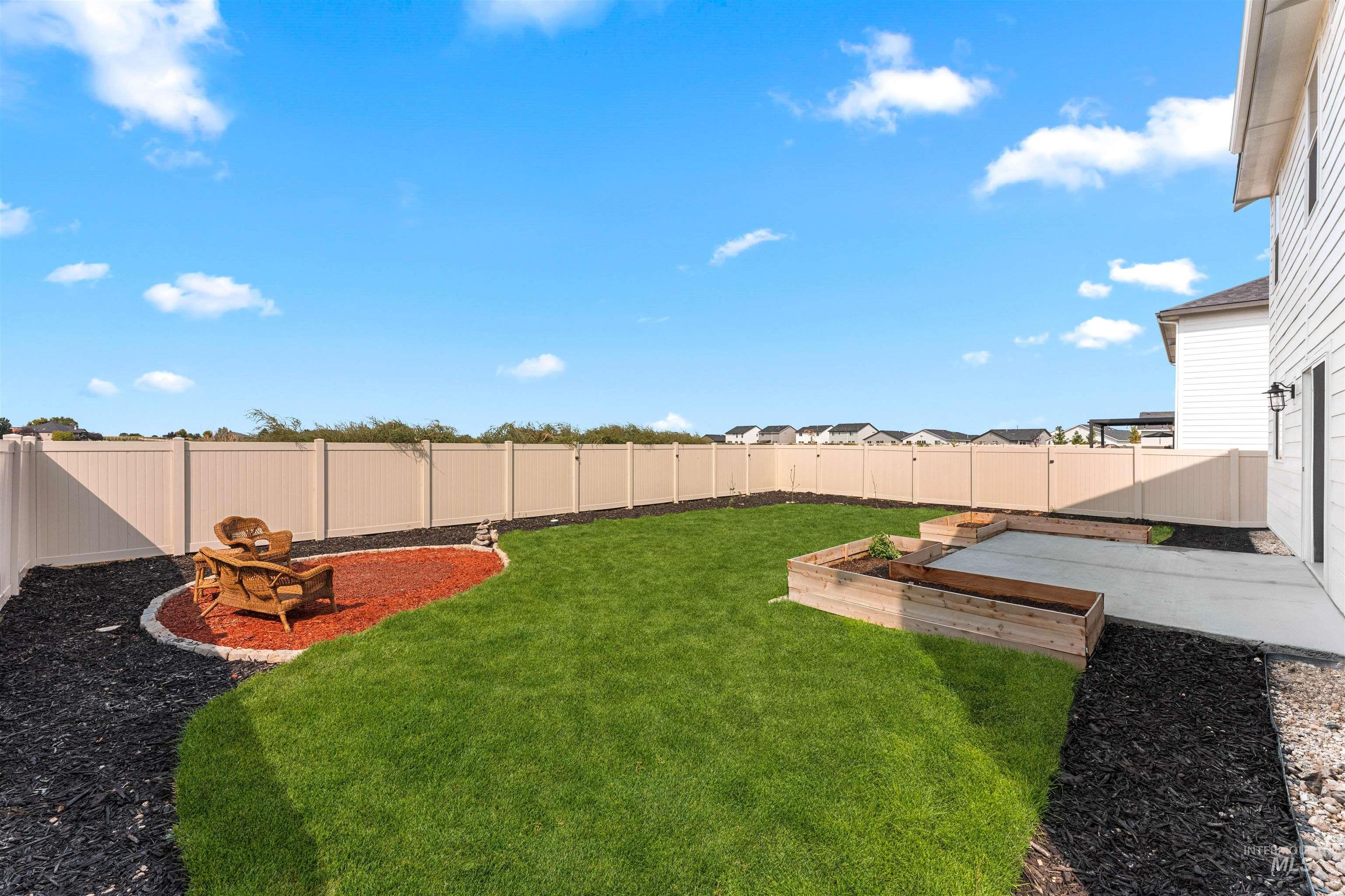 Fenced backyard with a garden and a patio