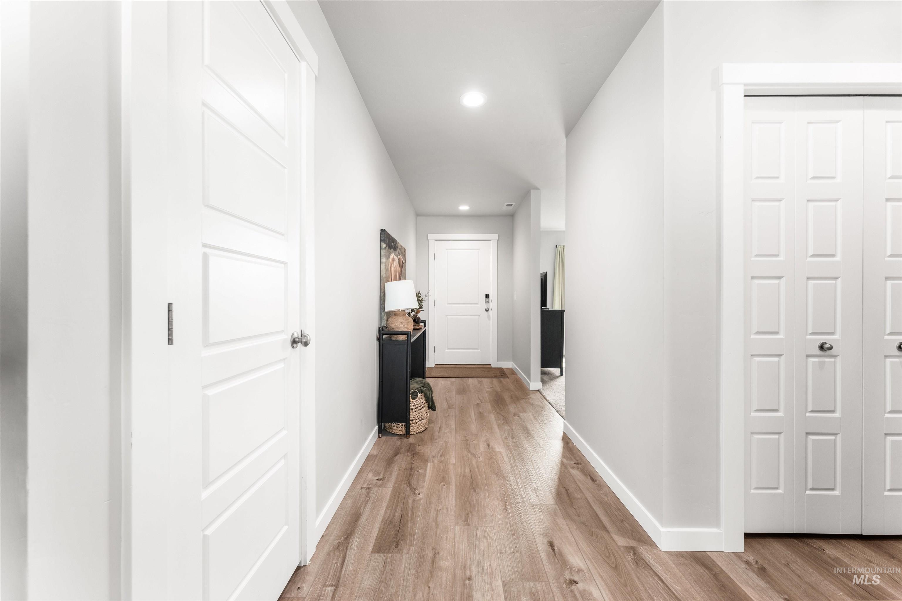 Hallway featuring recessed lighting and light wood-style floors