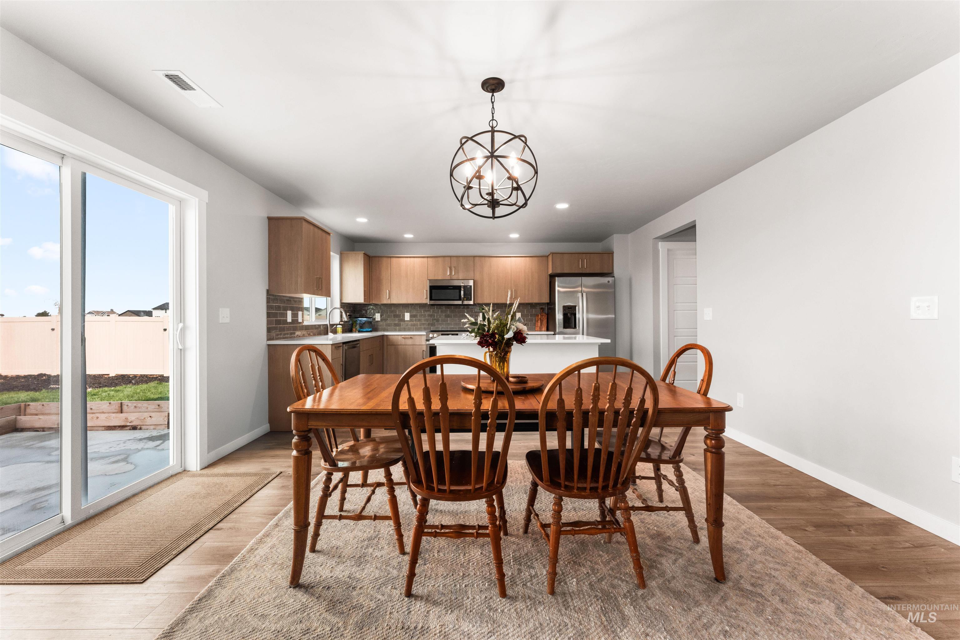 Dining area featuring recessed lighting, light wood-style floors, and a chandelier