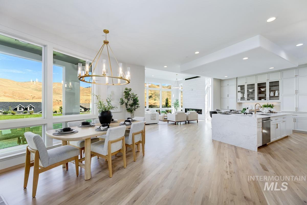 Dining room featuring light wood finished floors, recessed lighting, and a chandelier