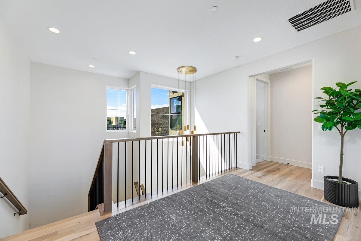 Hall with recessed lighting and light wood finished floors