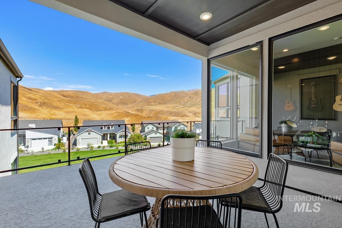 Balcony featuring a mountain view and a sunroom