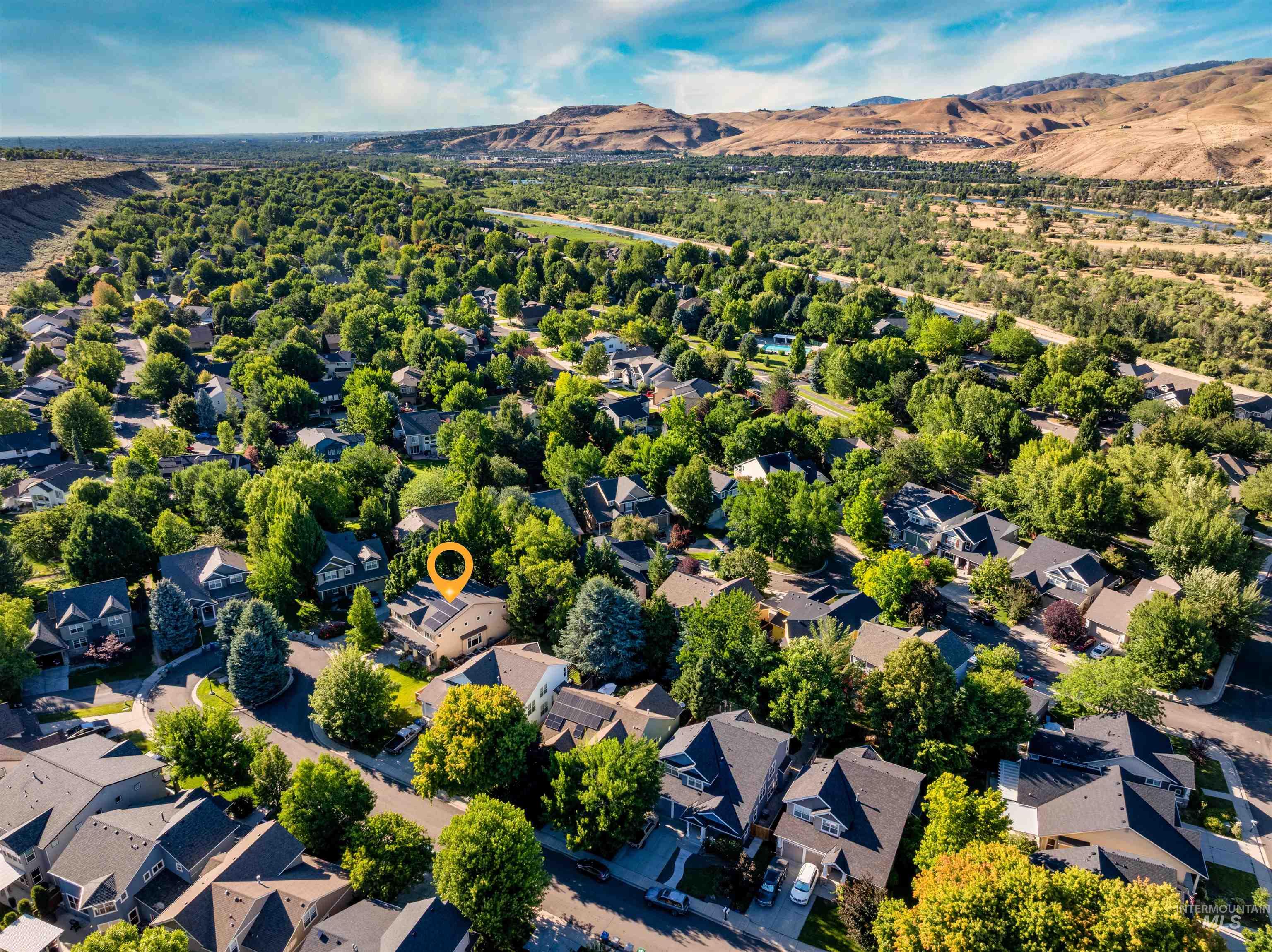 Aerial perspective of suburban area with a mountain backdrop