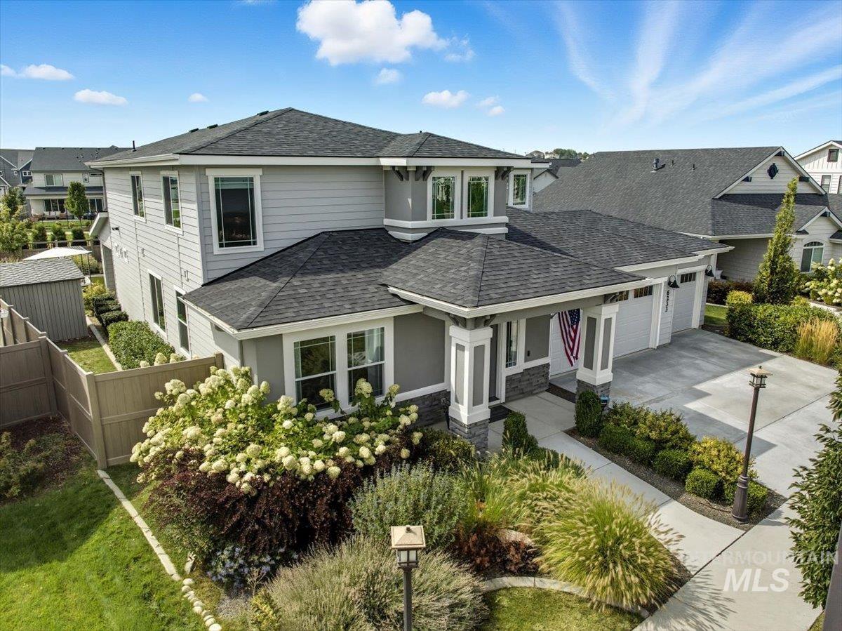 View of front of house with a shingled roof, concrete driveway, a garage, a porch, and stucco siding