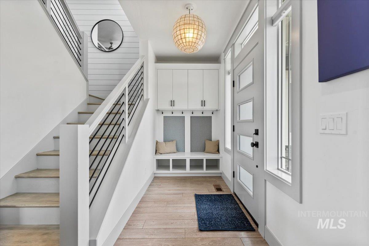 Mudroom featuring light wood-style floors and baseboards