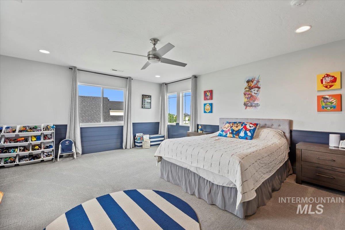 Bedroom with carpet flooring, ceiling fan, and recessed lighting