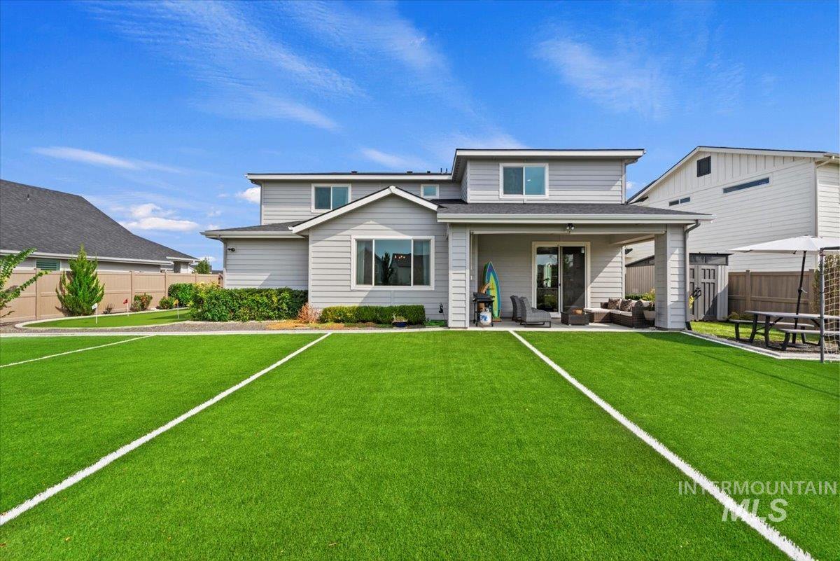 Back of house with outdoor lounge area and a patio