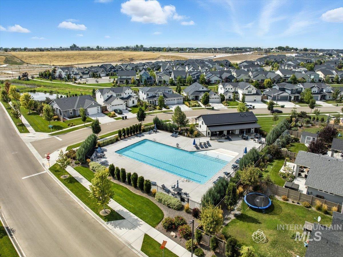 Aerial perspective of suburban area featuring a pool