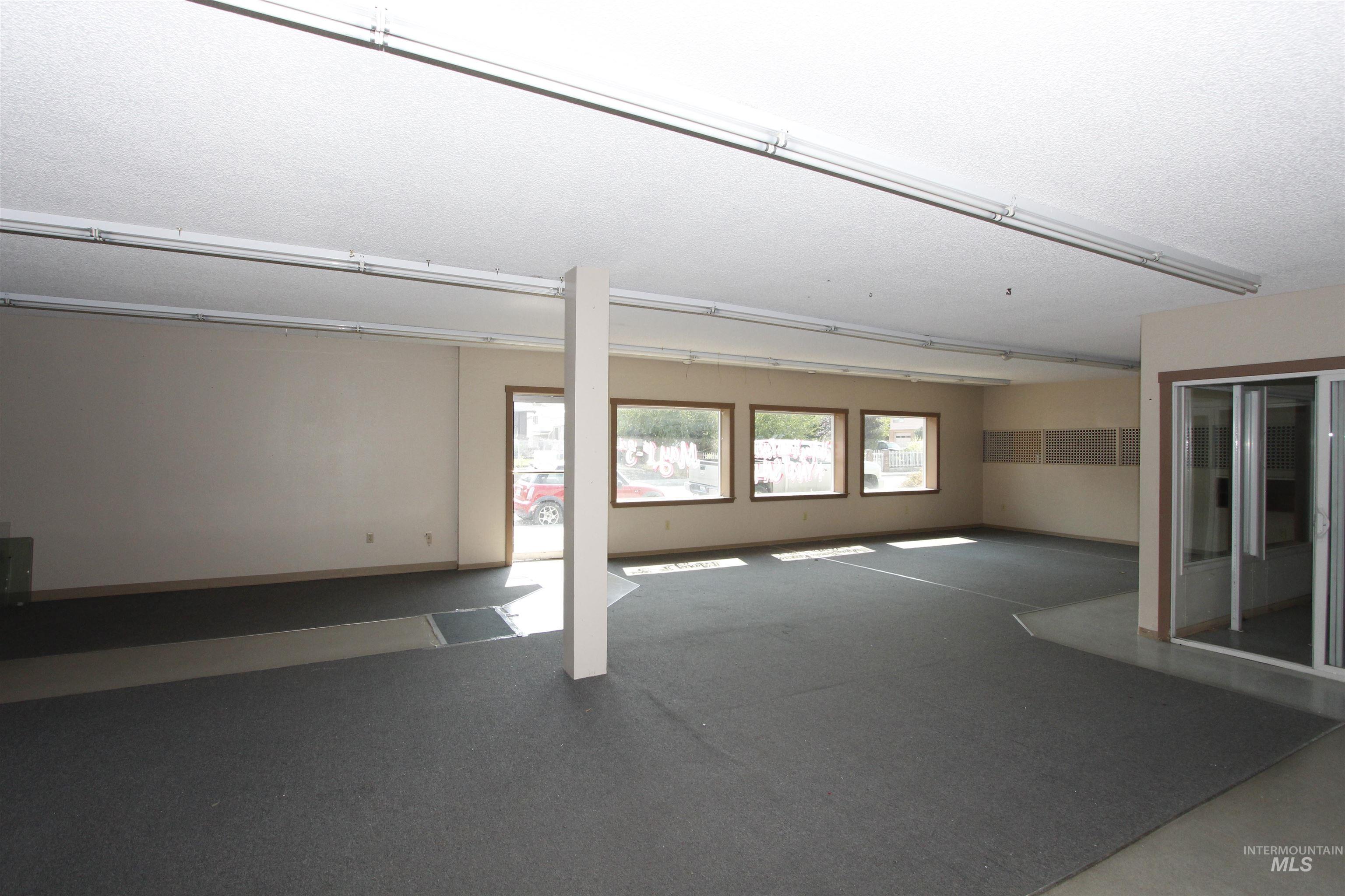Basement with baseboards and a textured ceiling