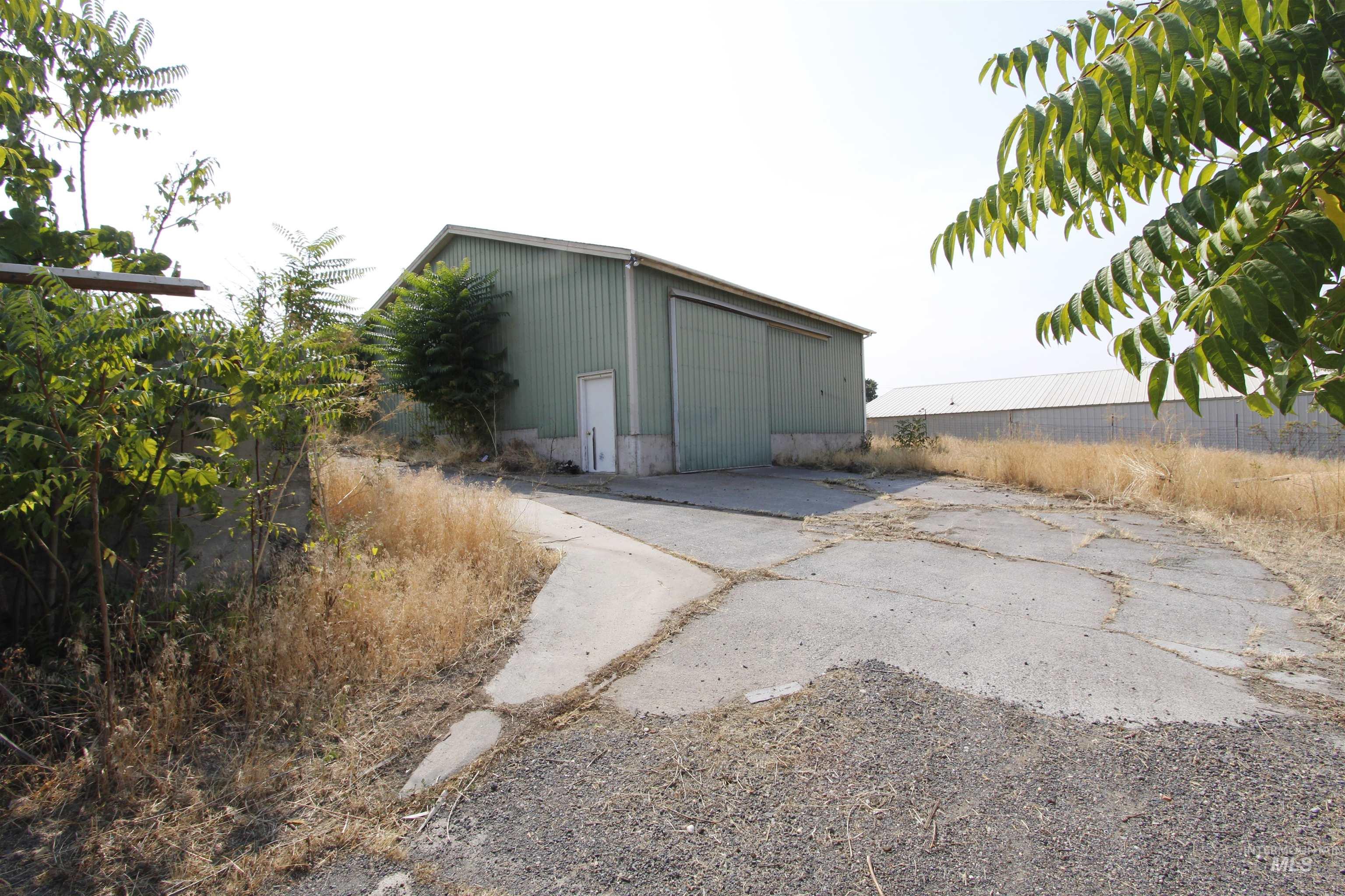 View of outdoor structure featuring driveway