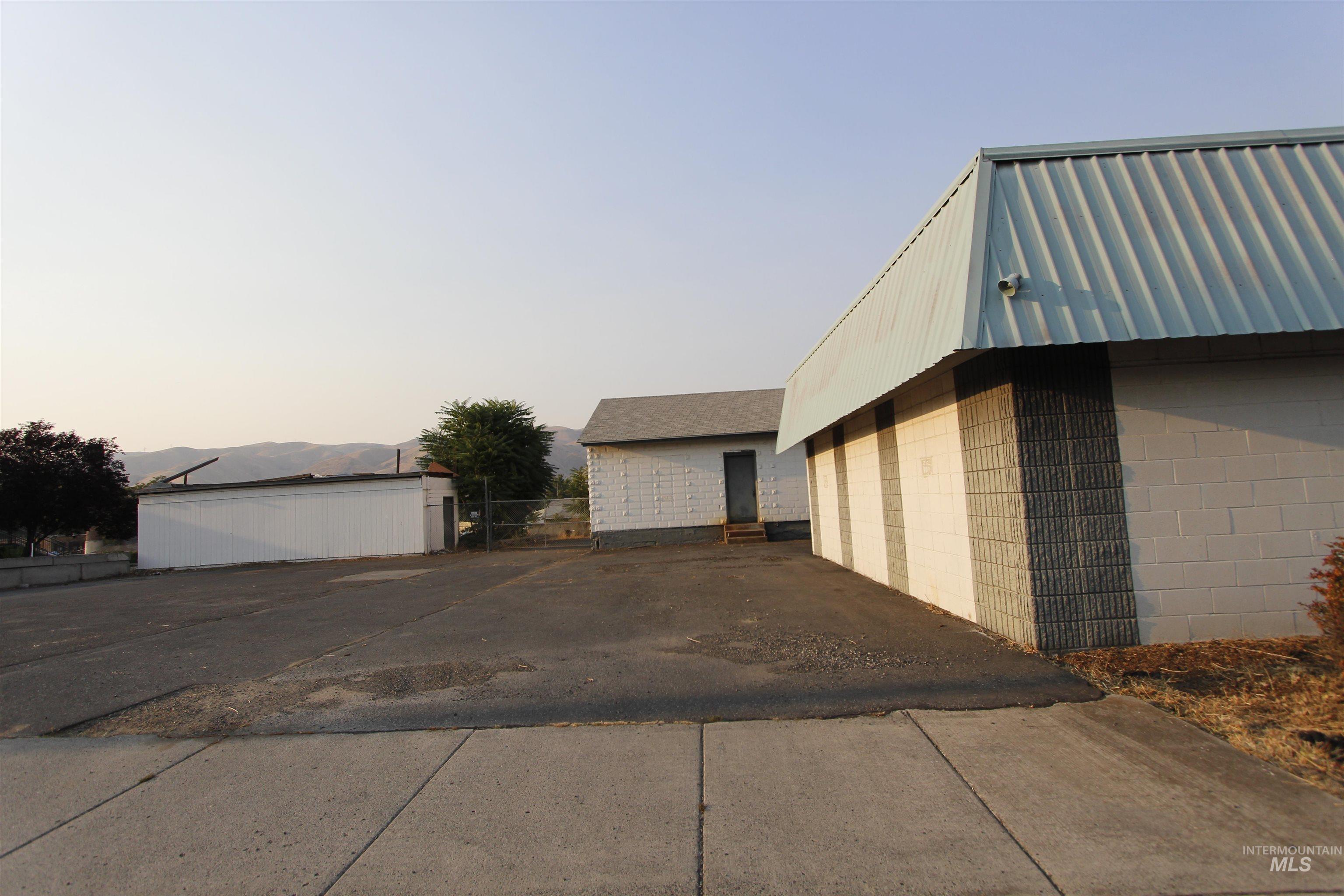 Property exterior at dusk featuring an outdoor structure, concrete block siding, and a mountain view