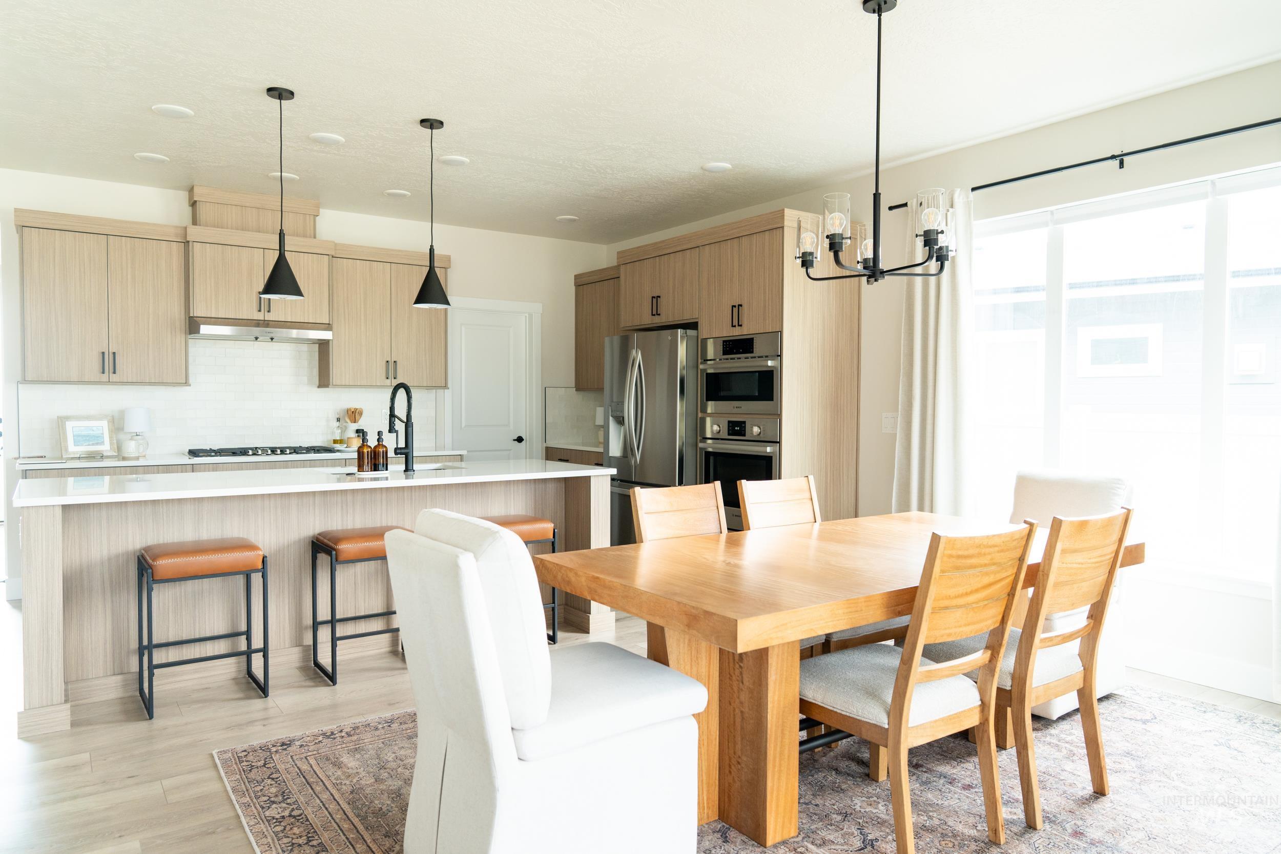 Dining space with a chandelier and light wood-type flooring