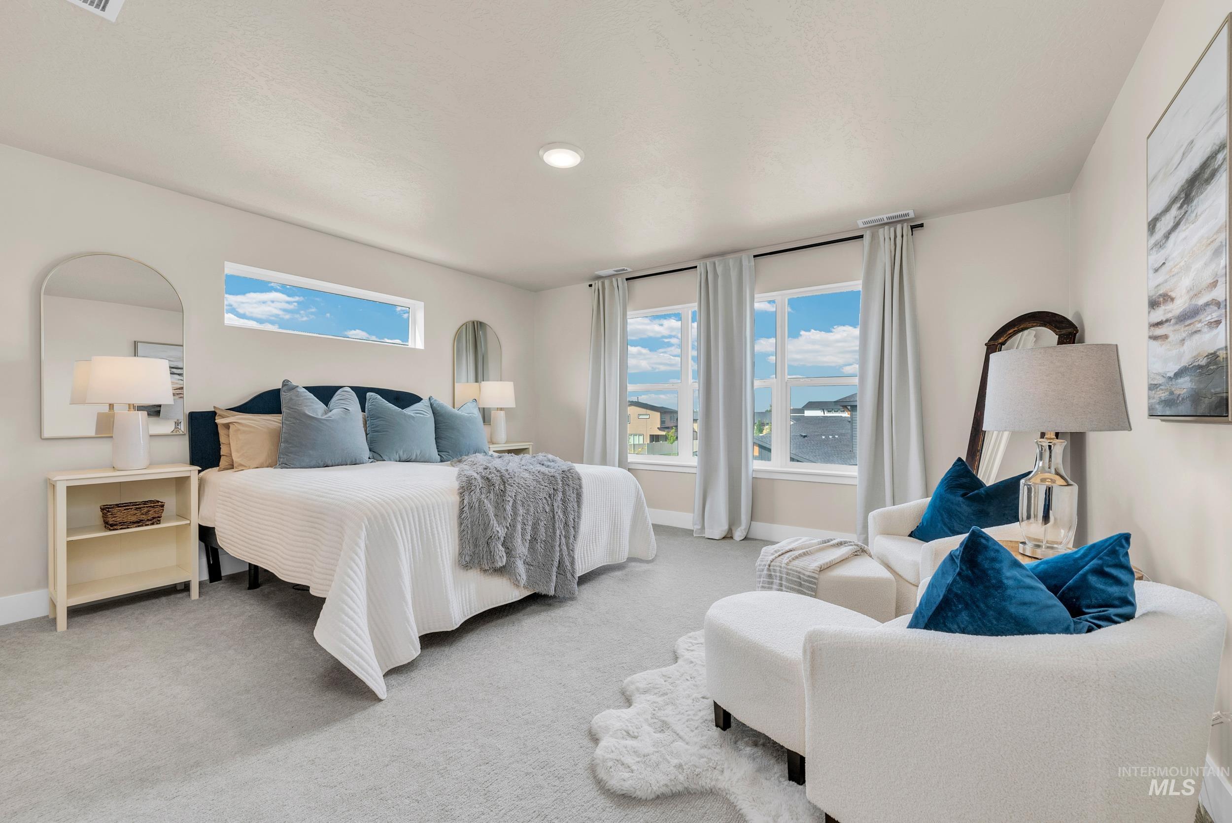 Bedroom with light colored carpet and baseboards
