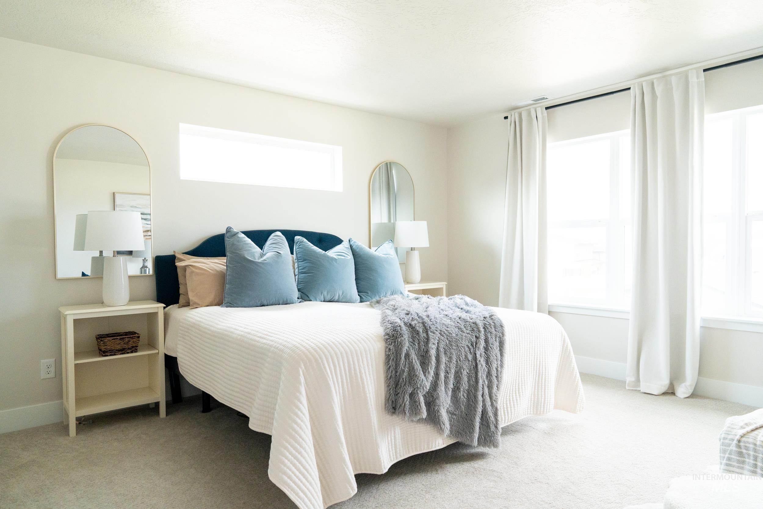 Carpeted bedroom with multiple windows