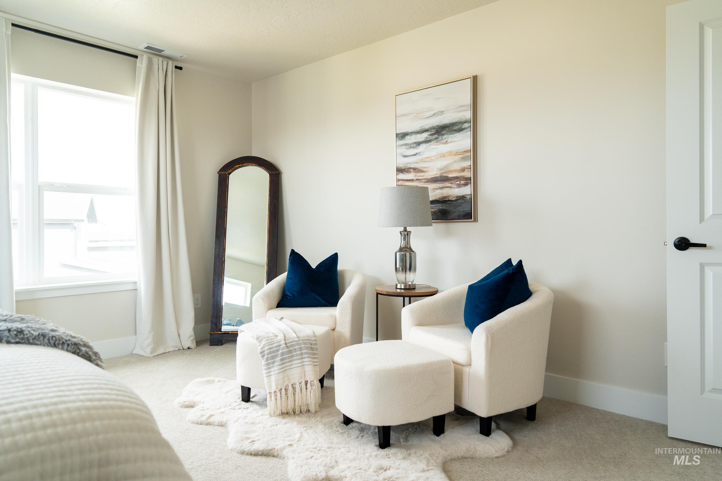 Bedroom featuring light carpet and baseboards