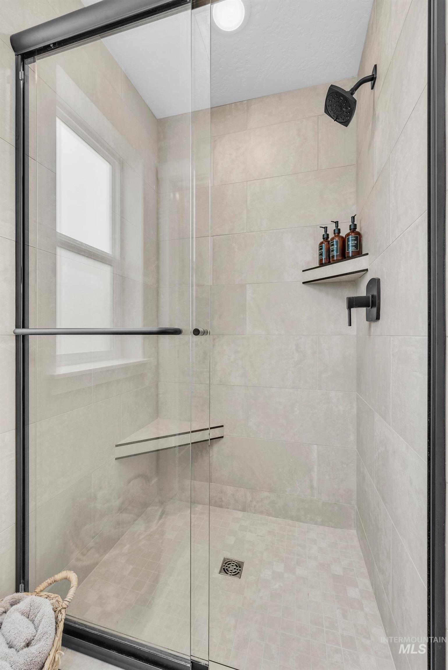 Full bathroom featuring a shower stall
