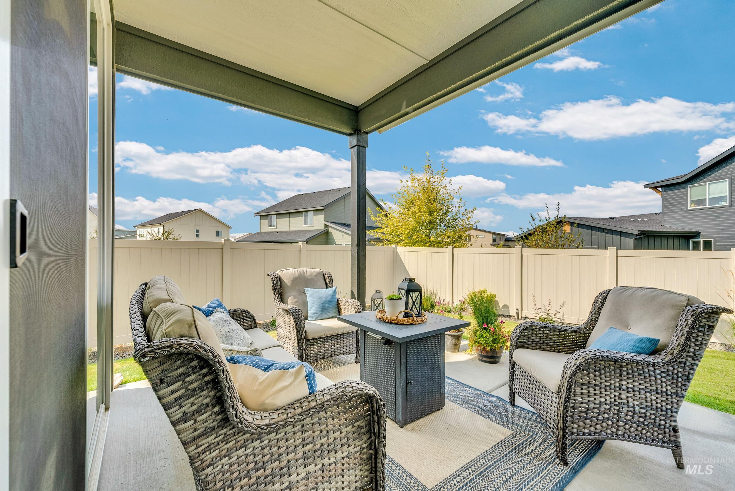 Fenced backyard with a patio and an outdoor hangout area