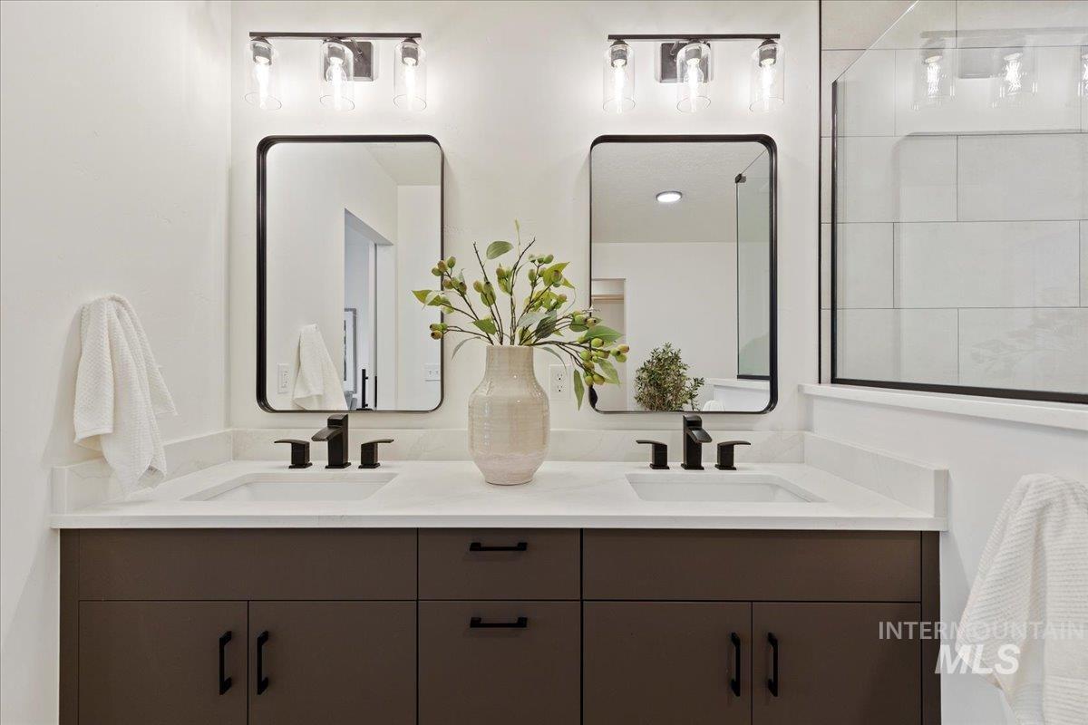 Full bathroom with double vanity and a shower