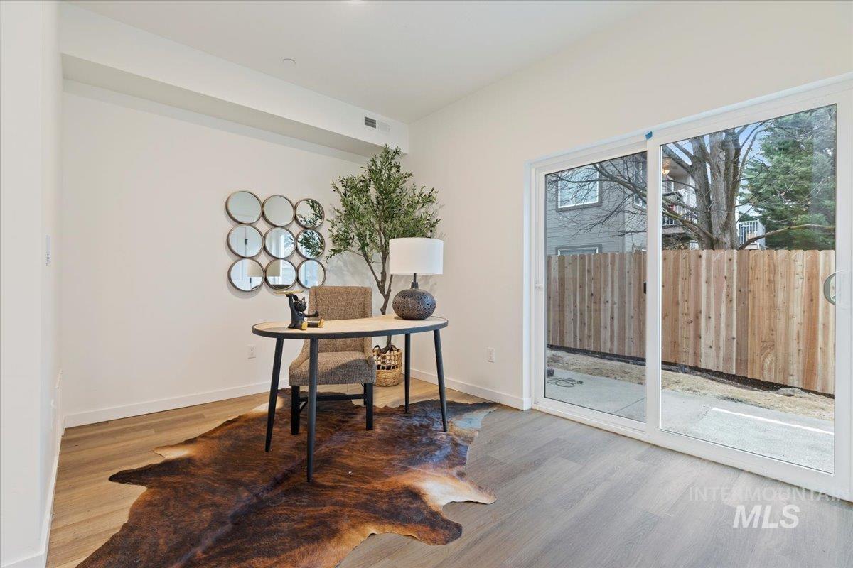 Office space featuring light wood-style floors and baseboards