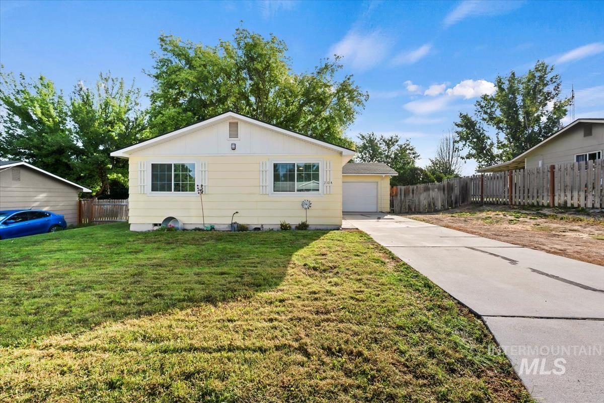 View of property exterior featuring board and batten siding, concrete driveway, and a garage
