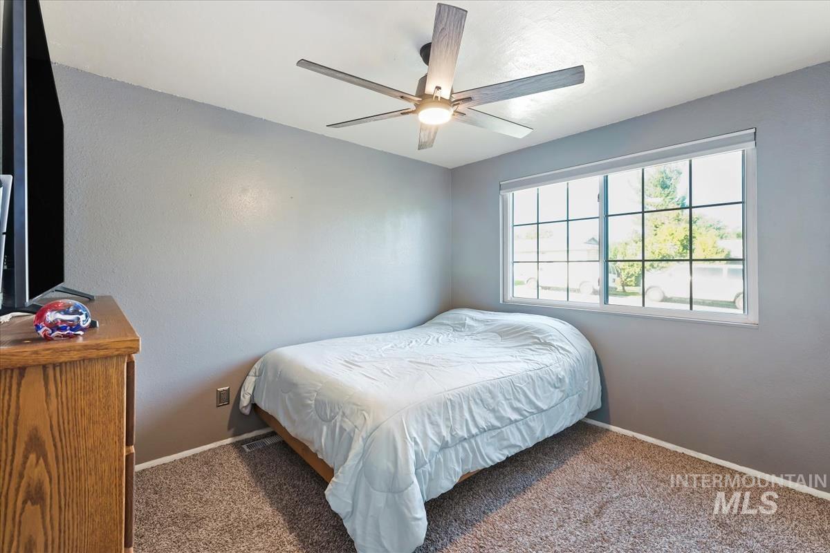 Bedroom with carpet flooring and ceiling fan