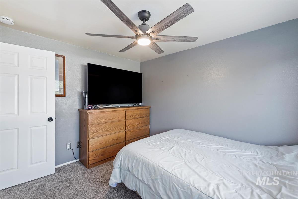 Bedroom with carpet floors and a ceiling fan