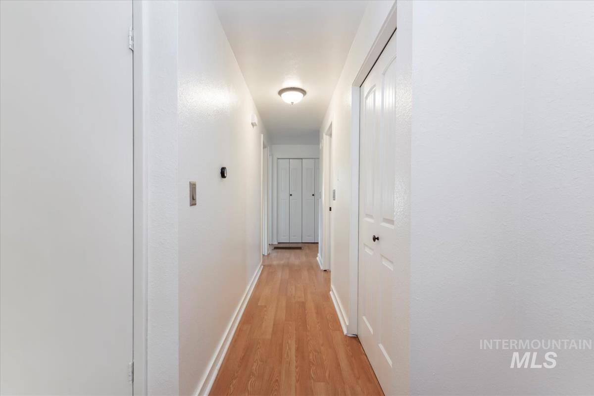 Hall featuring light wood finished floors and baseboards