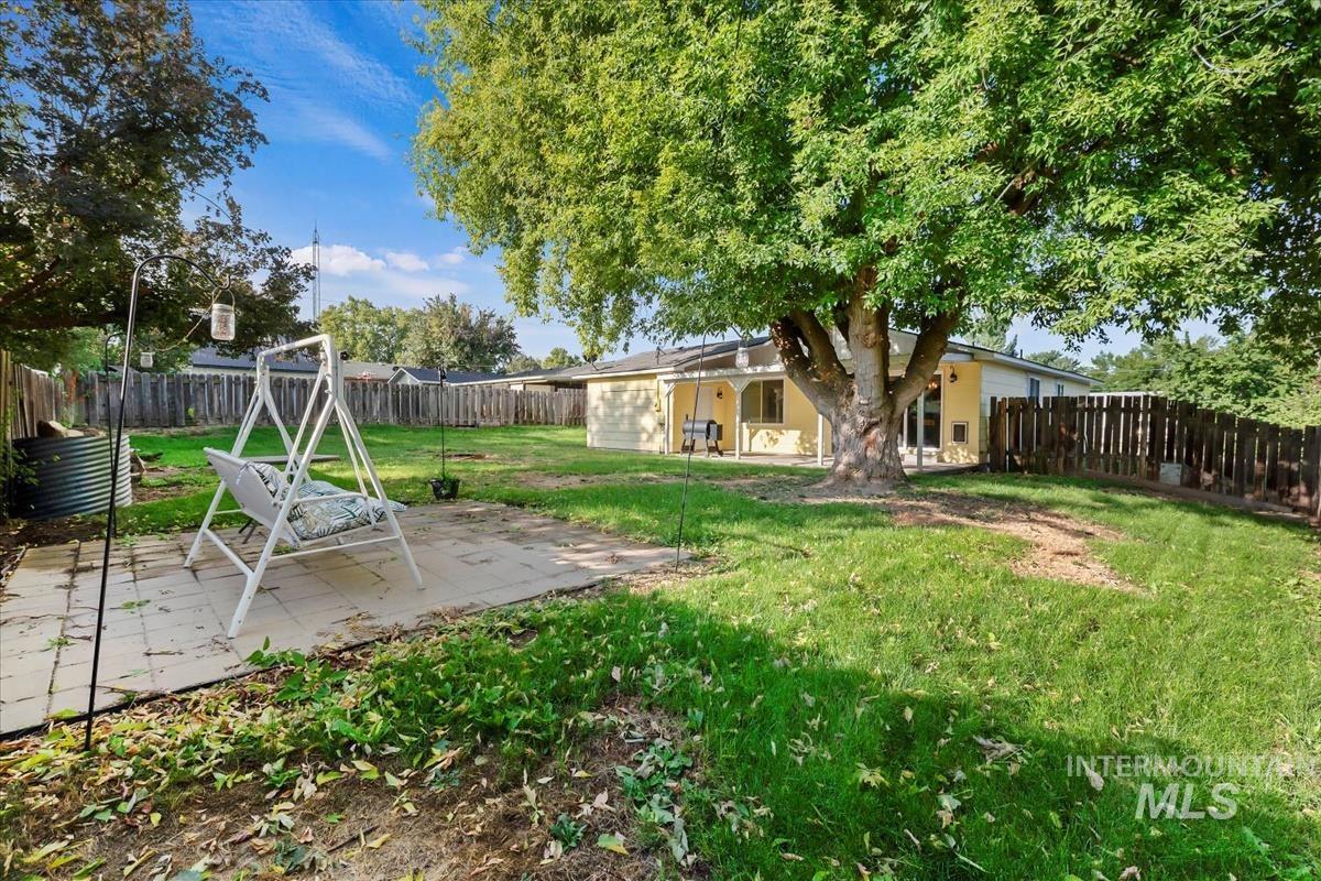 Fenced backyard with a patio