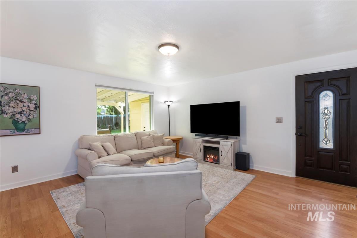 Living room with light wood finished floors and baseboards