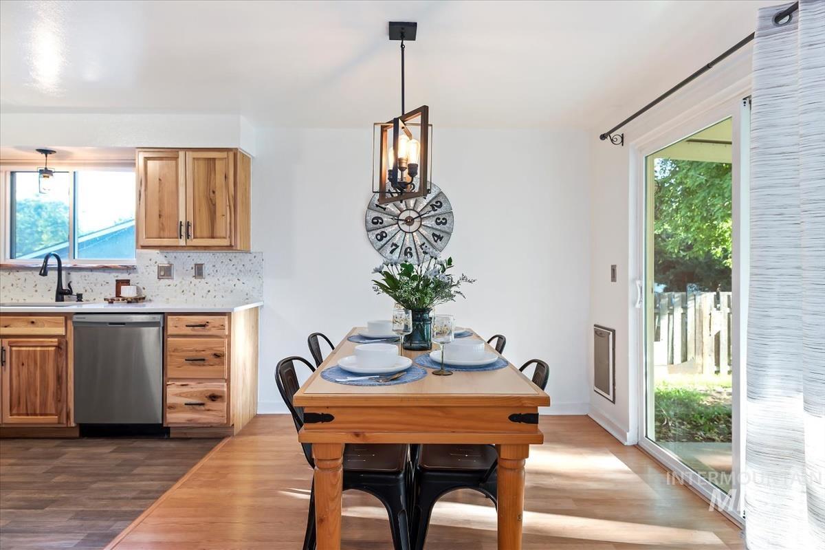 Dining space with plenty of natural light and dark wood-type flooring