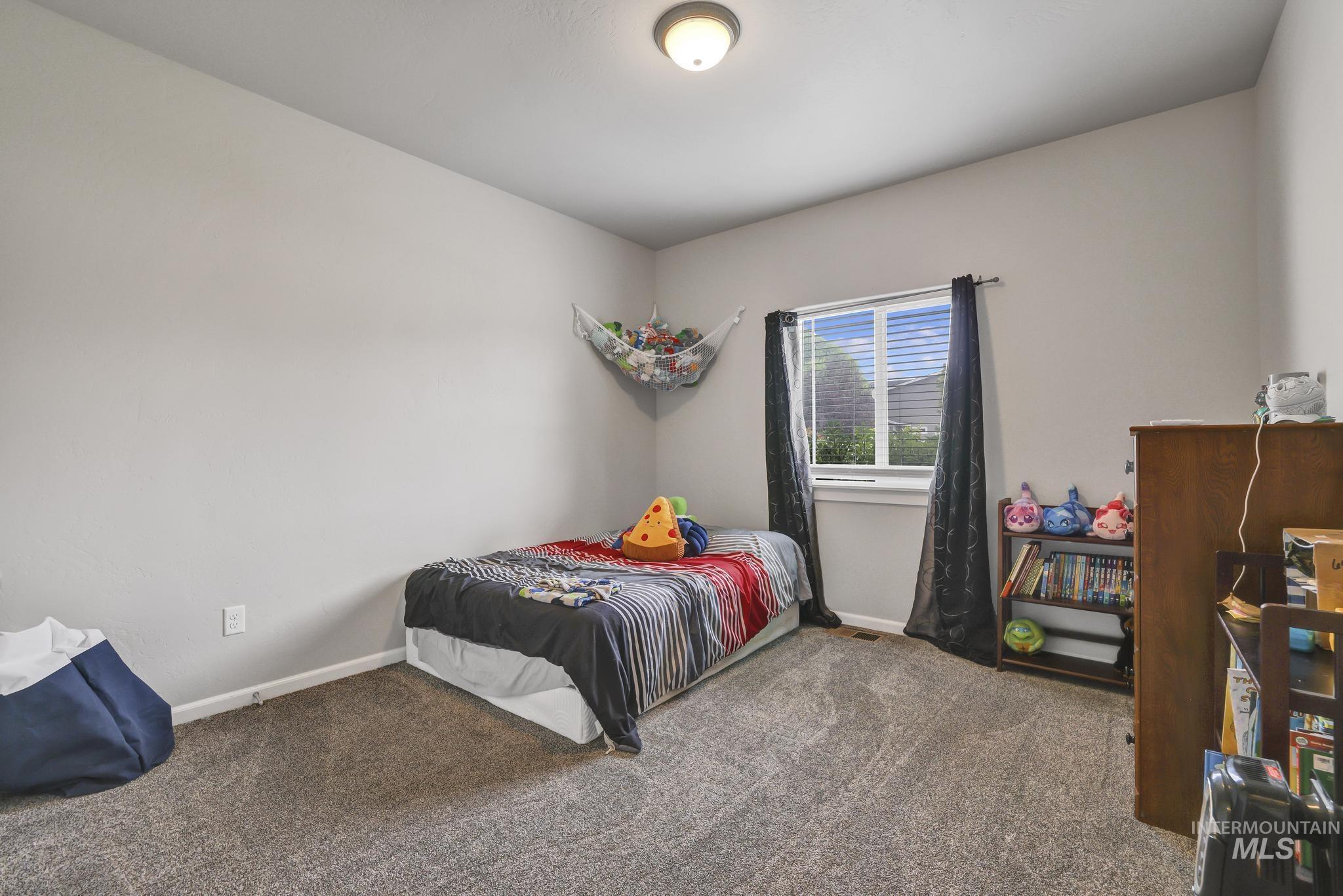 Carpeted bedroom with baseboards