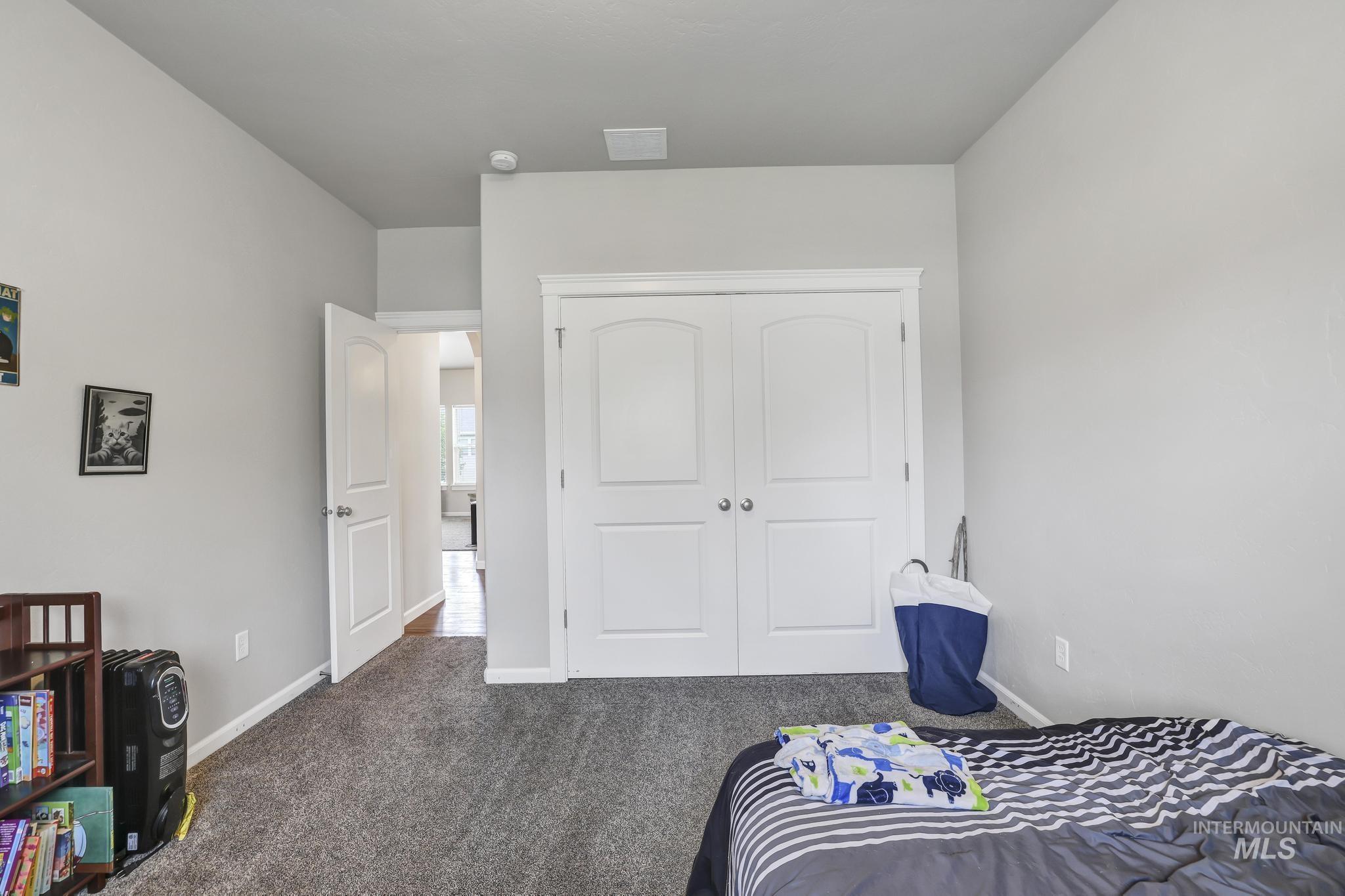 Bedroom featuring carpet floors and a closet