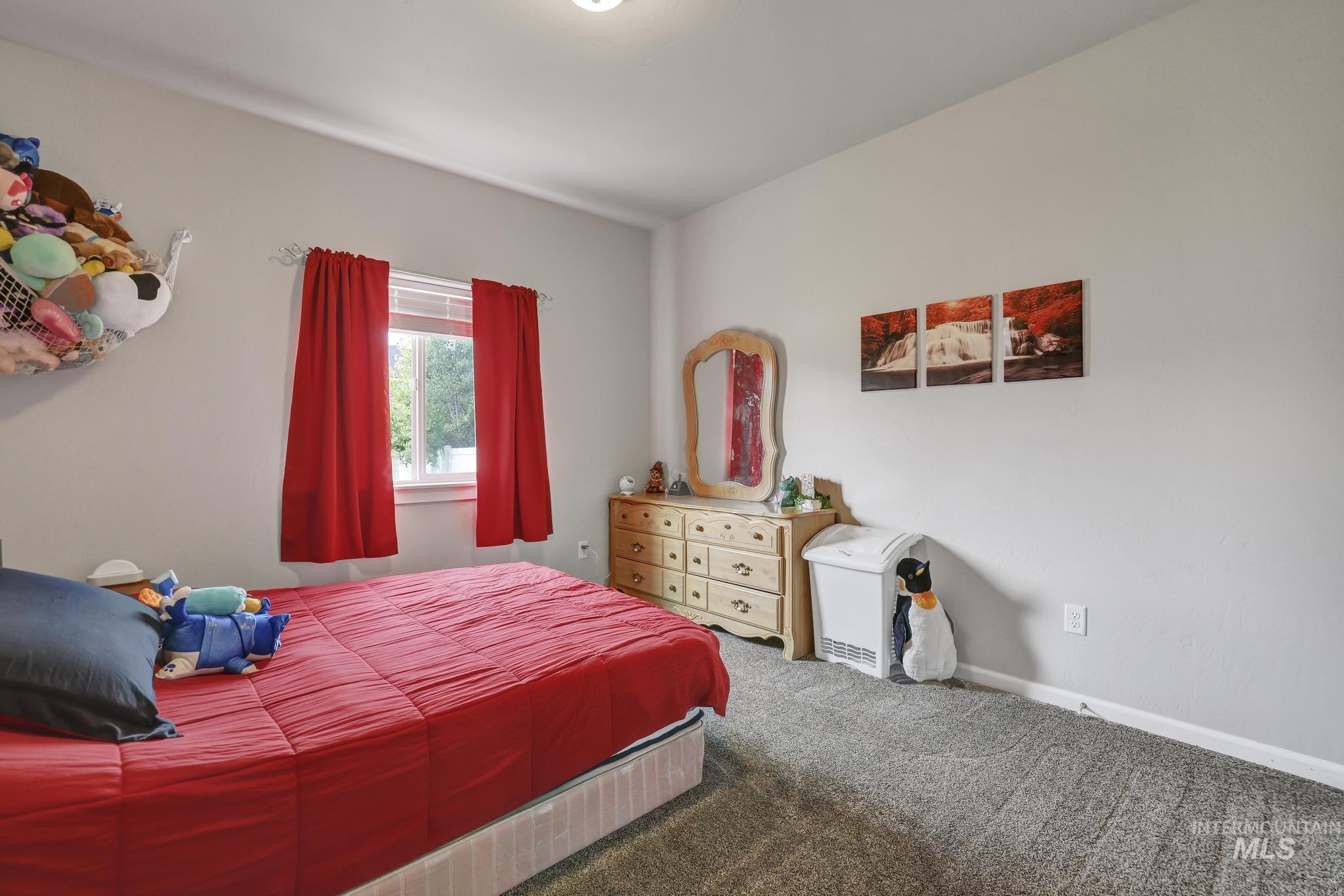 Bedroom featuring carpet floors and baseboards