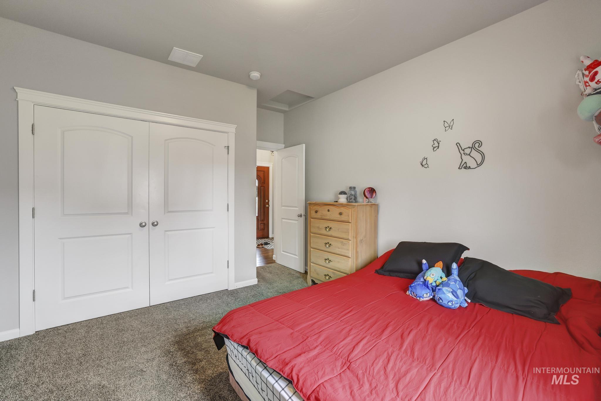 Carpeted bedroom featuring a closet