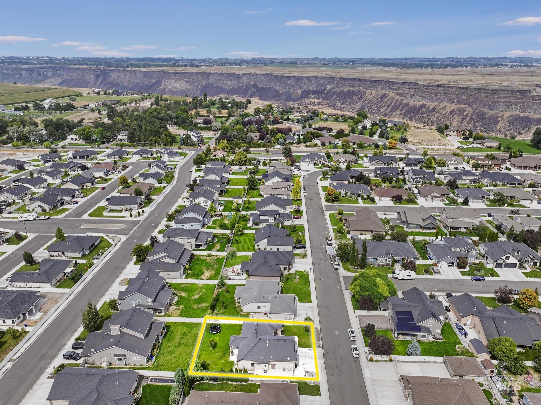 Aerial view of residential area with property parcel outlined