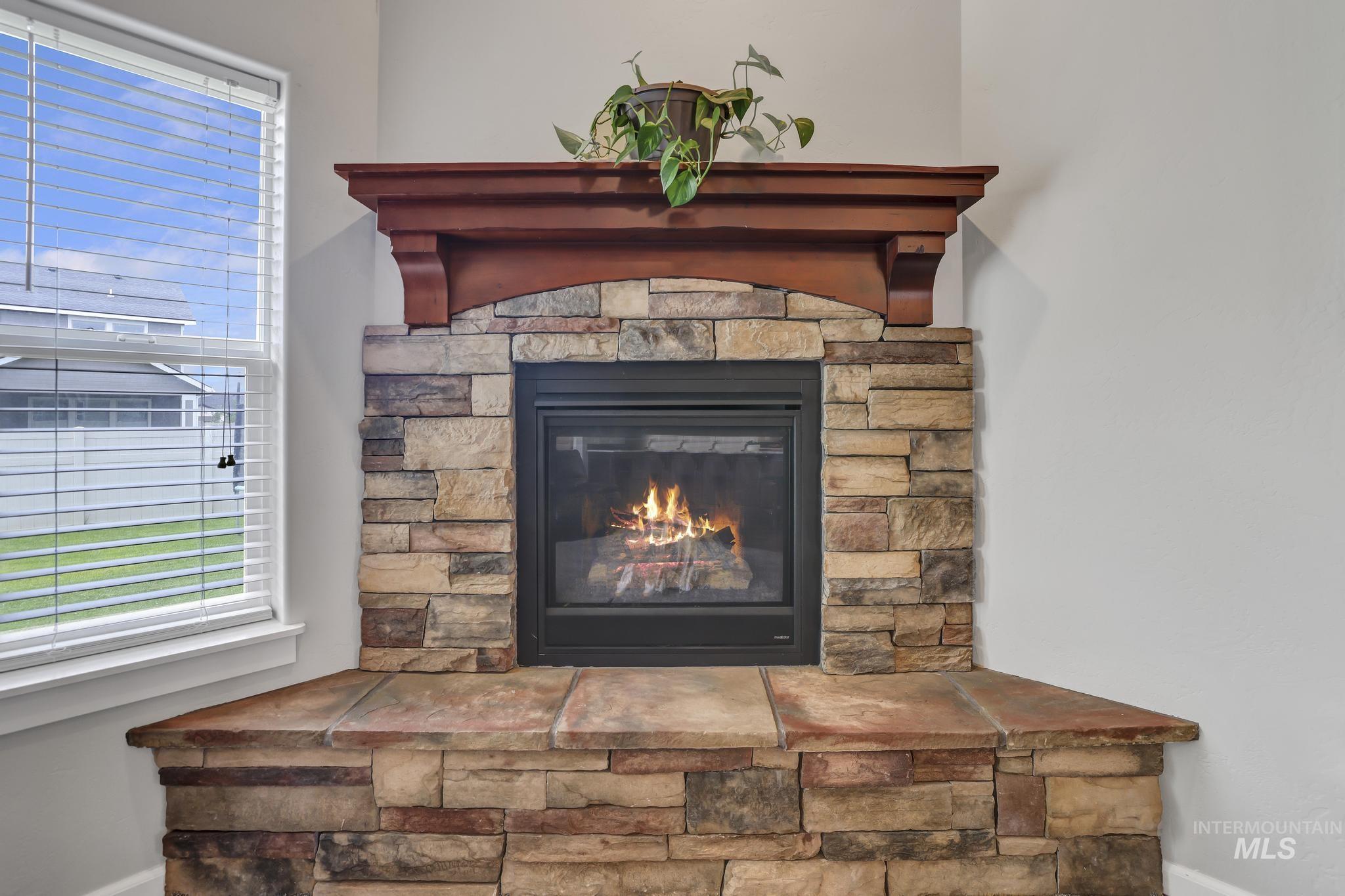 Detailed view of baseboards and a stone fireplace