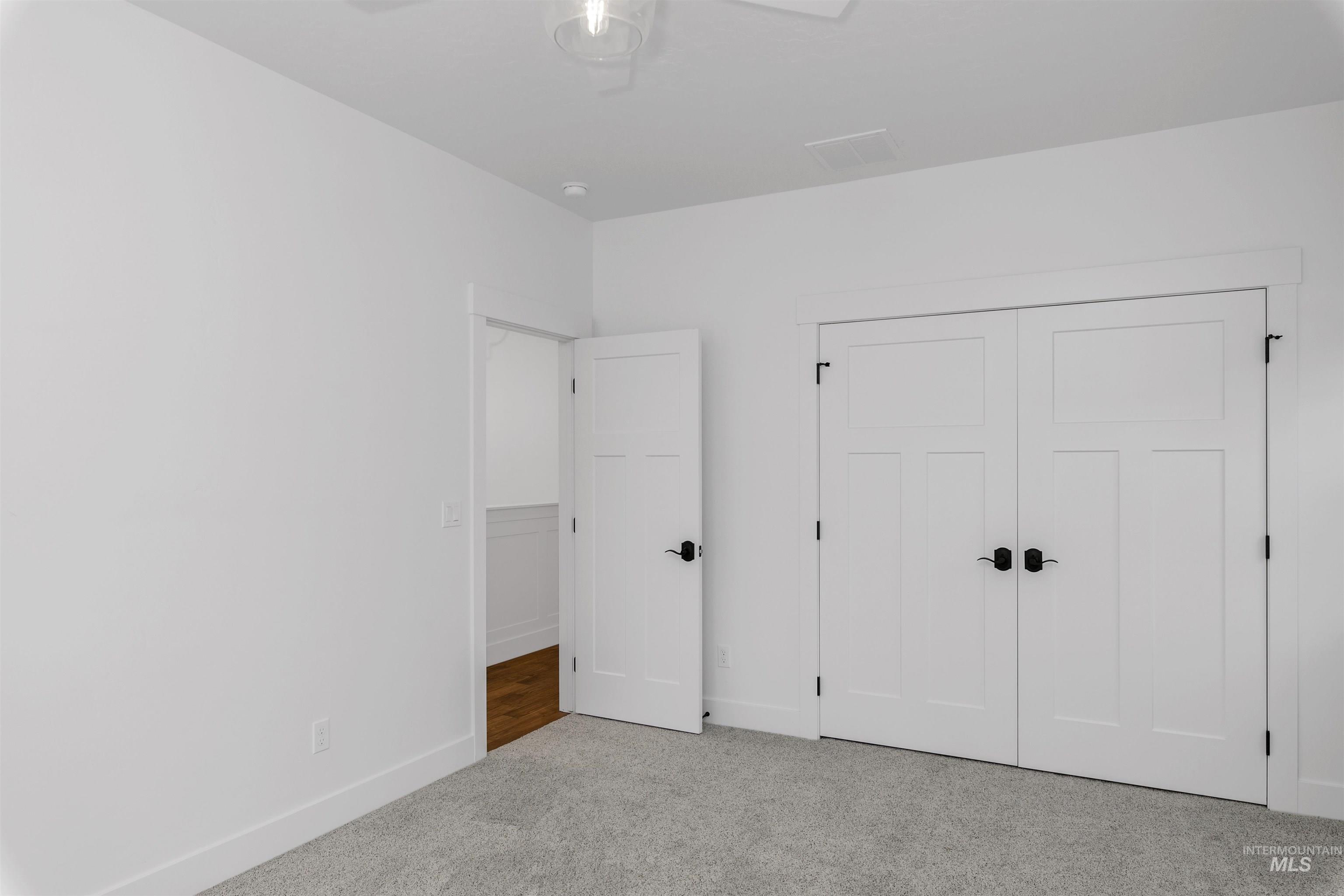 Unfurnished bedroom with carpet and a closet