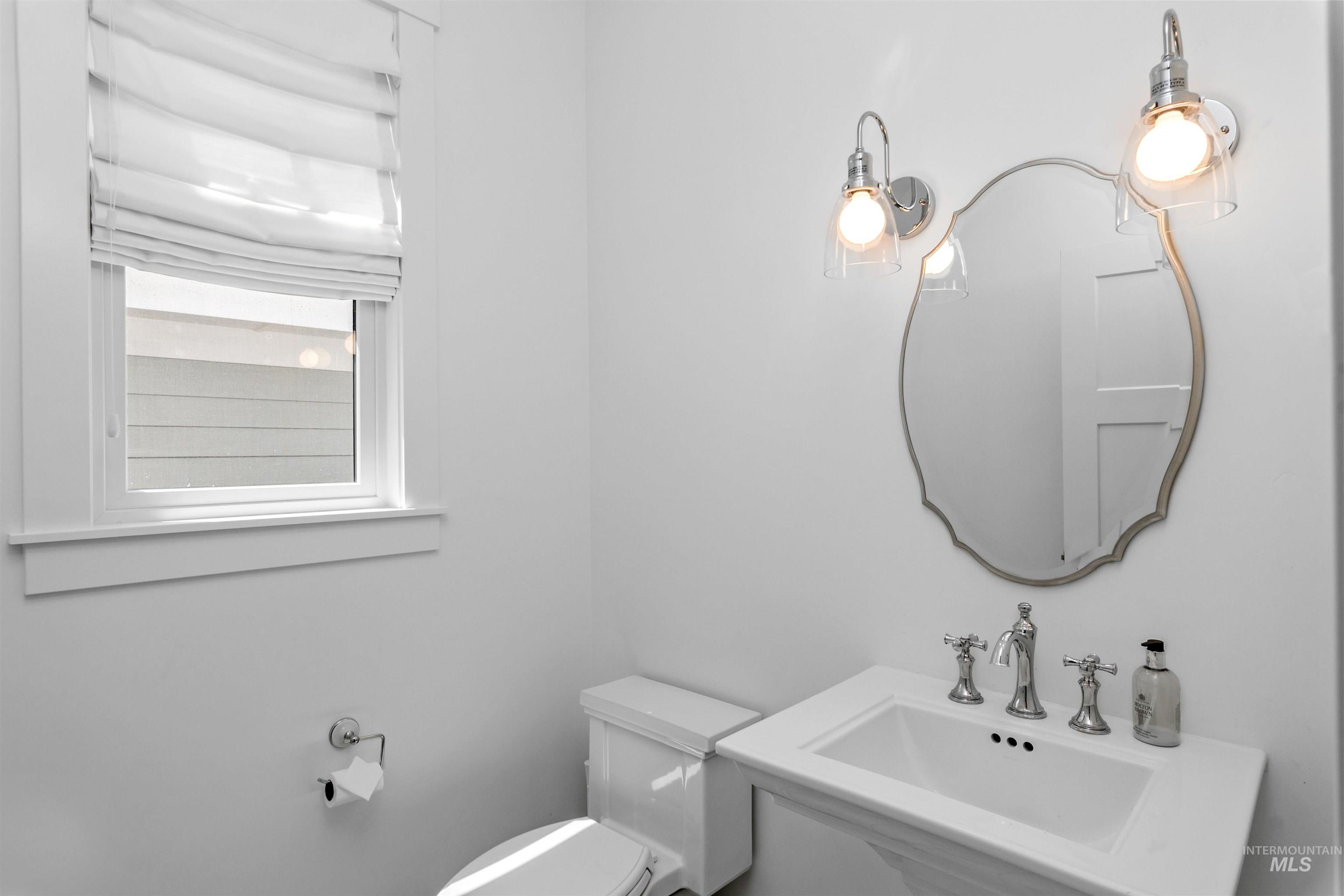 Half bathroom featuring toilet and a sink