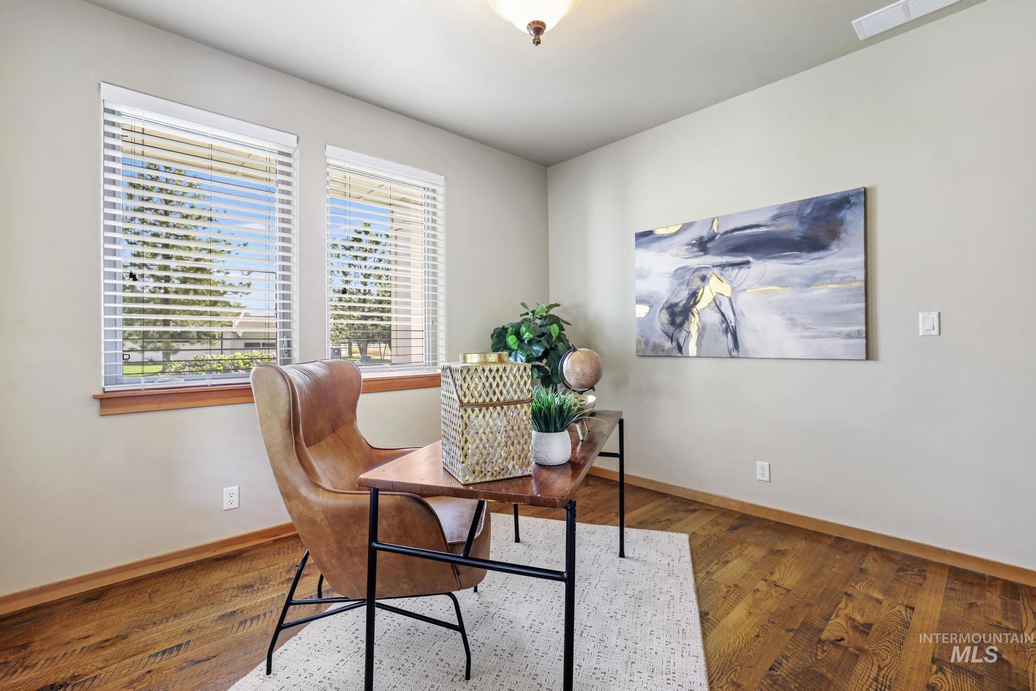 Office space with wood finished floors and baseboards