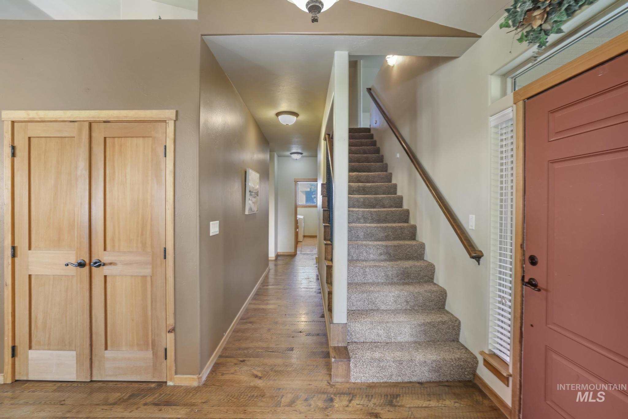 Stairs with wood-type flooring and baseboards
