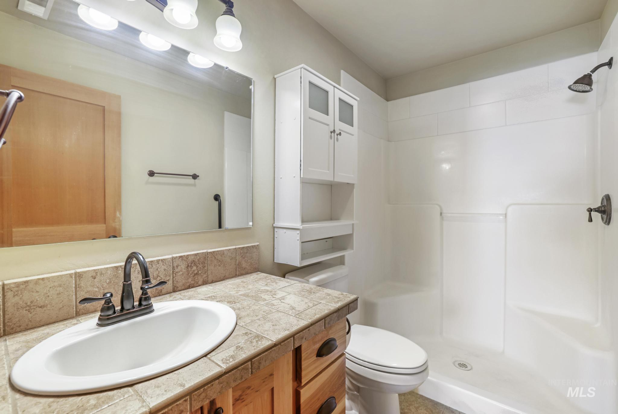 Bathroom with vanity and a stall shower