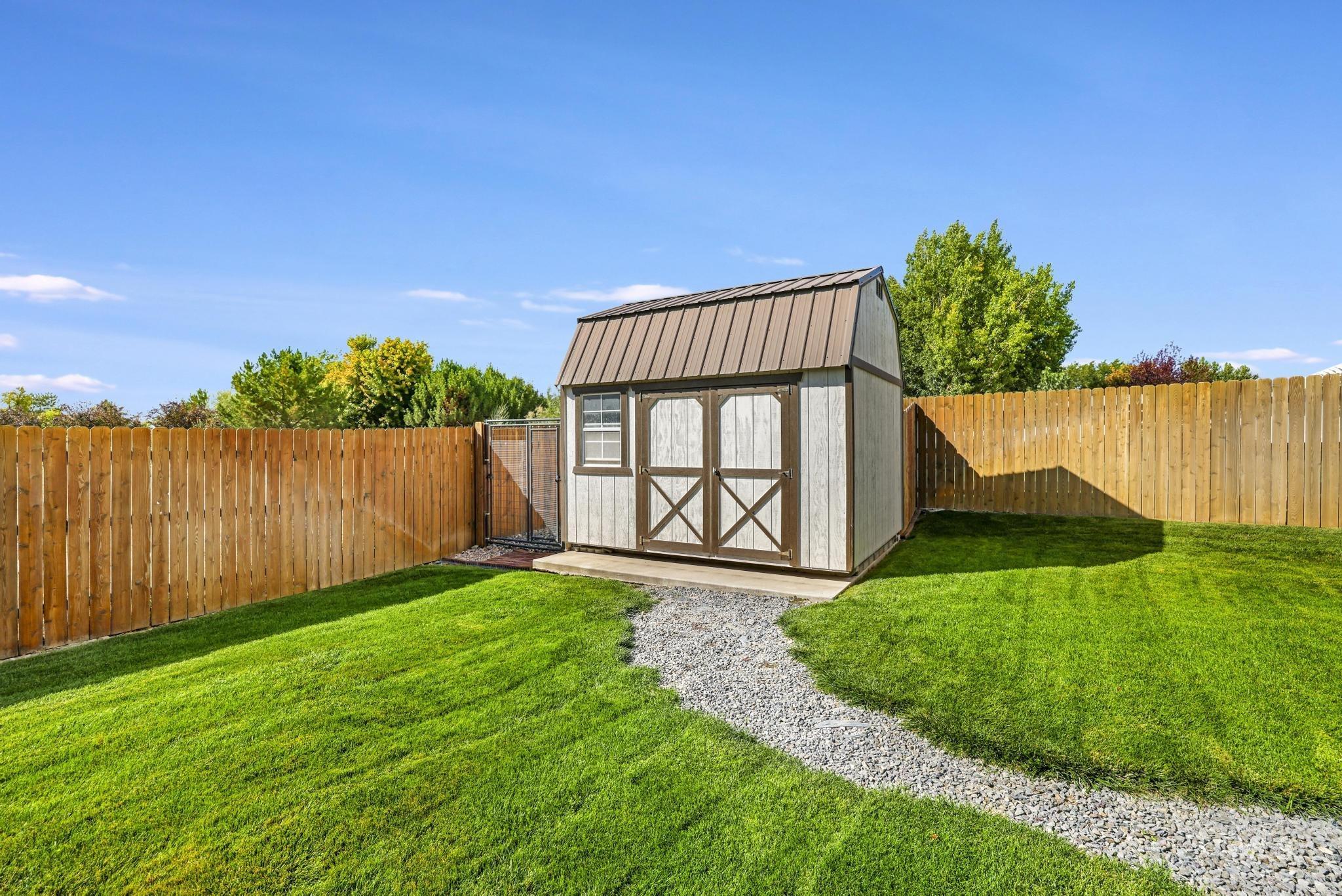 View of shed with a fenced backyard