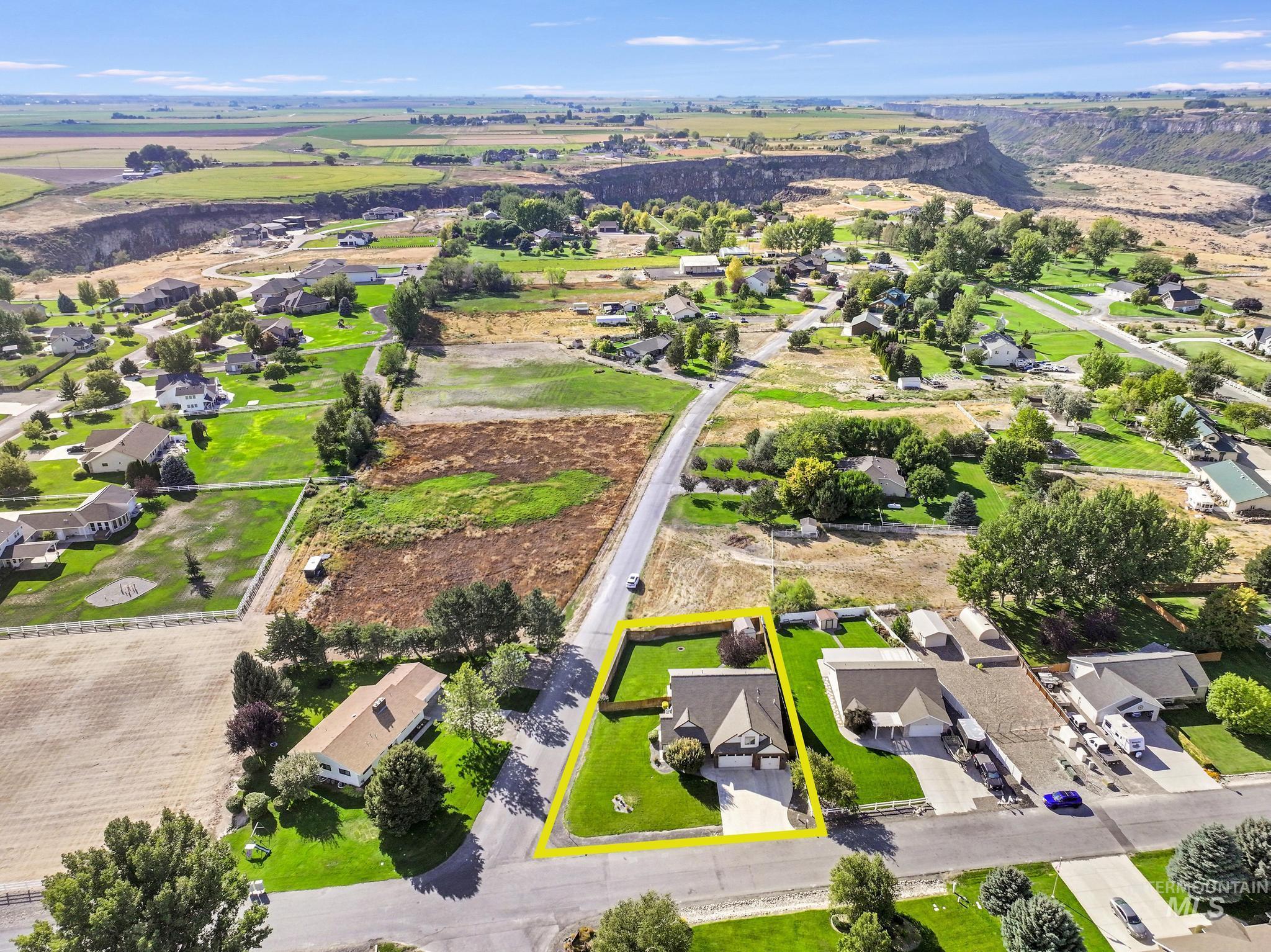 Aerial view of property's location with property parcel outlined and nearby suburban area