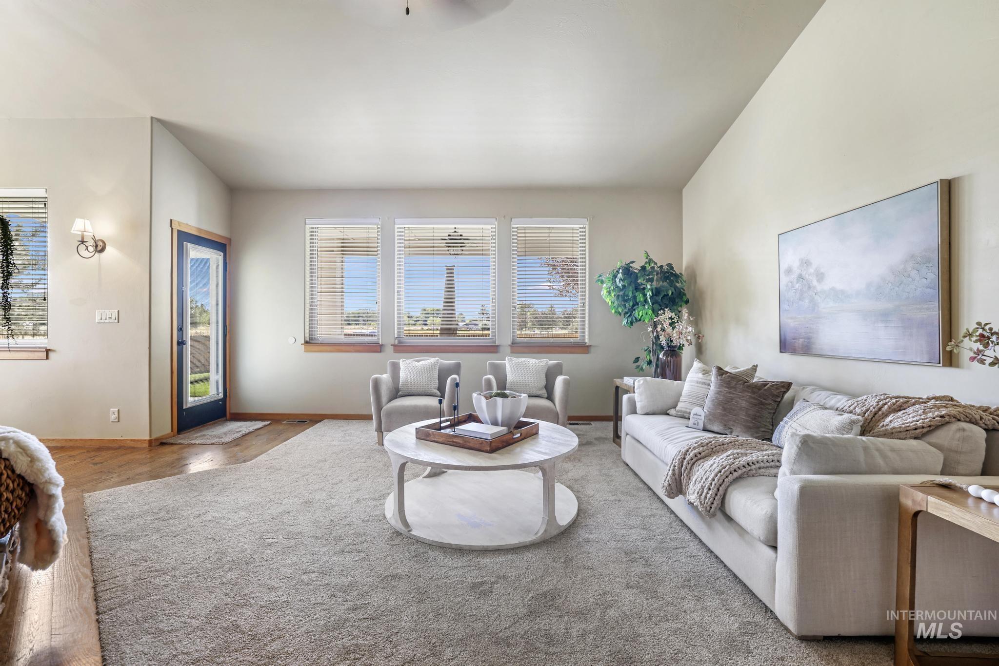 Living area featuring baseboards and ceiling fan