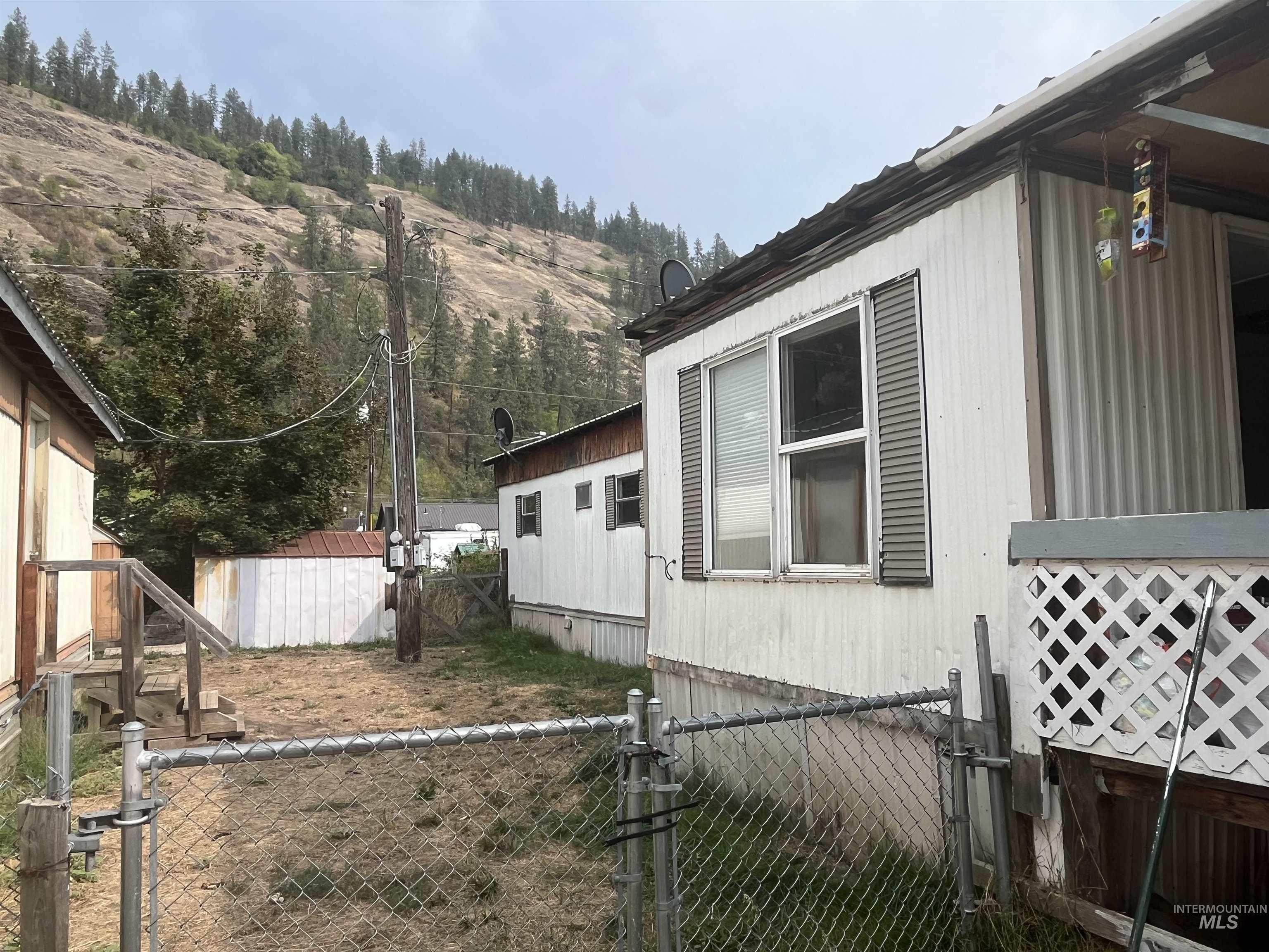 View of side of property featuring a gate