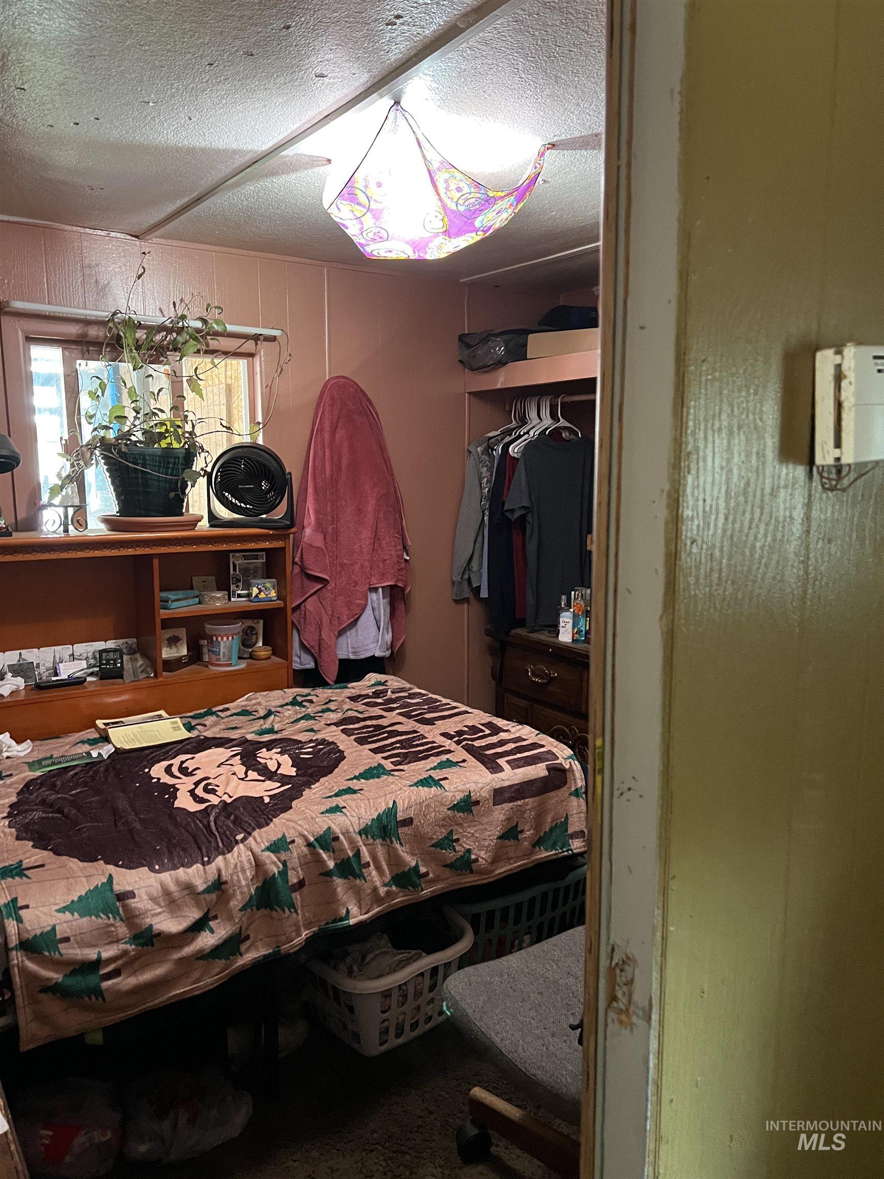 Bedroom featuring a closet and a textured ceiling