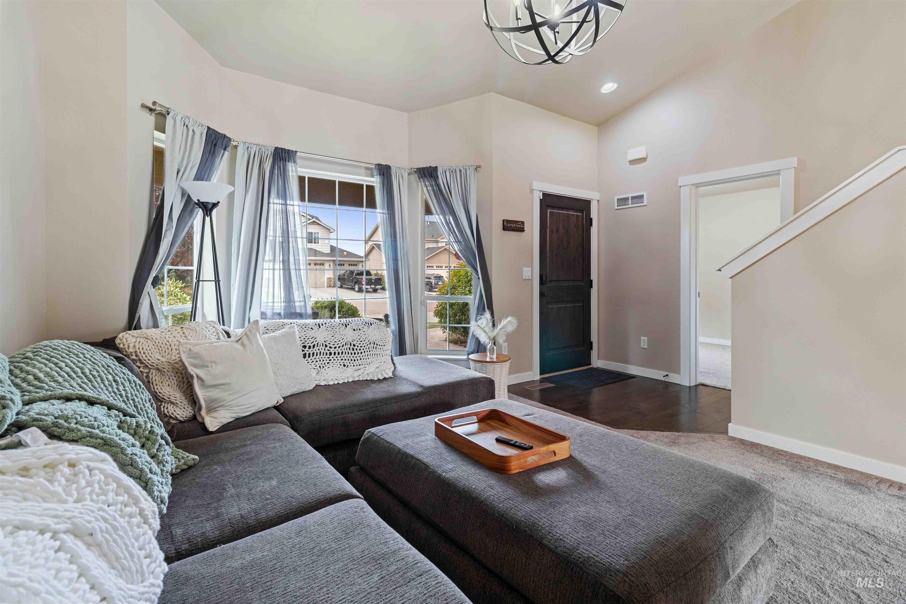 Living area with recessed lighting, a chandelier, and wood finished floors